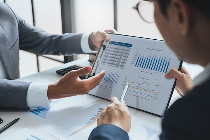 Two people sharing data on computer screen