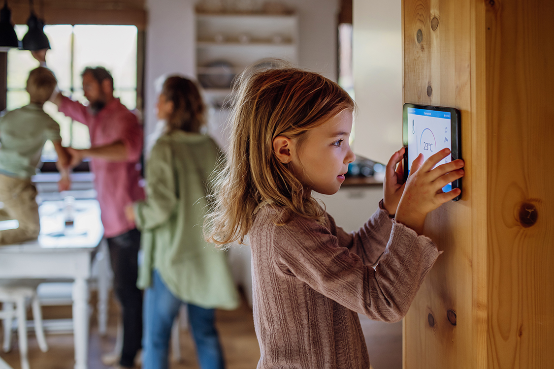 Girl using smart thermostat