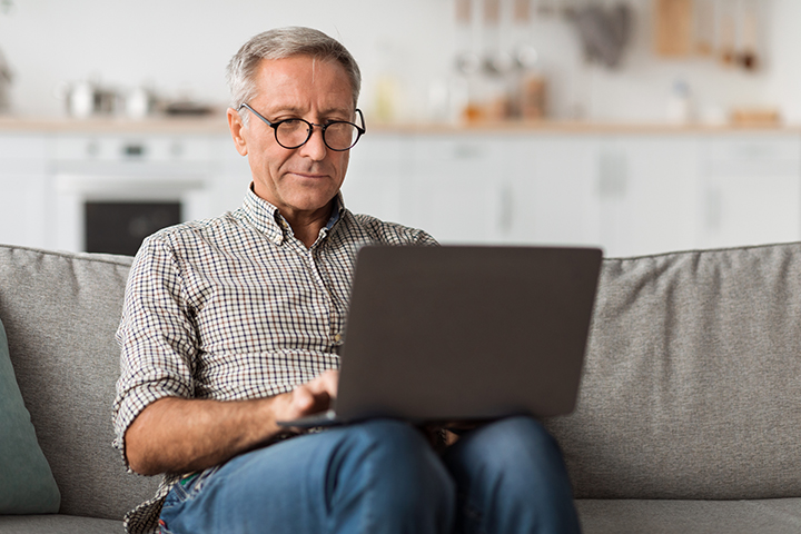 Man at home using computer