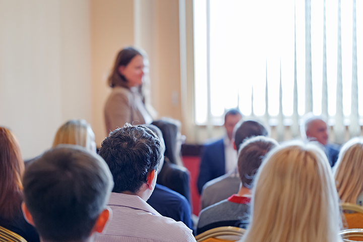 Person spaeking in medium sized meeting