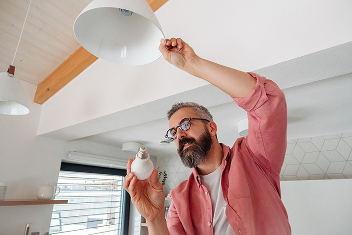 man installing smartbulb