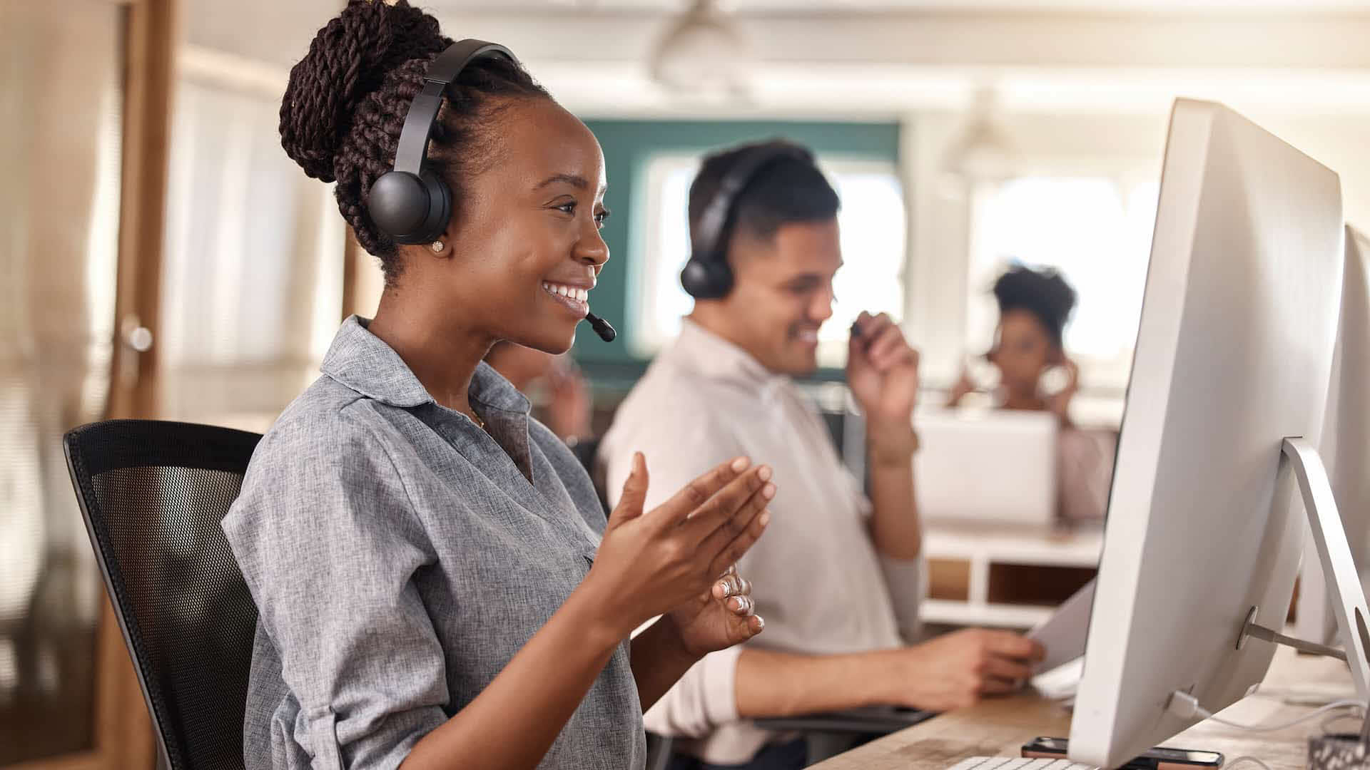 CSRs take calls at their computers