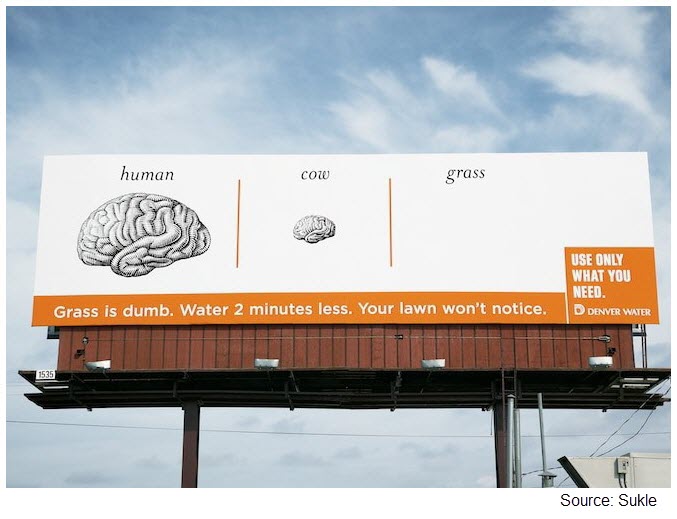 Photo of a billboard with a human brain, a cow brain, and nothing labeled 'grass'; the caption reads Grass is dumb. Water 2 minutes less. Your lawn won't notice.
