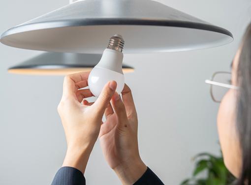 Person installing LED bulb